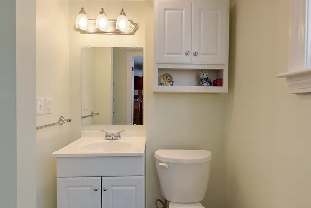 a bathroom with a sink a toilet and mirror