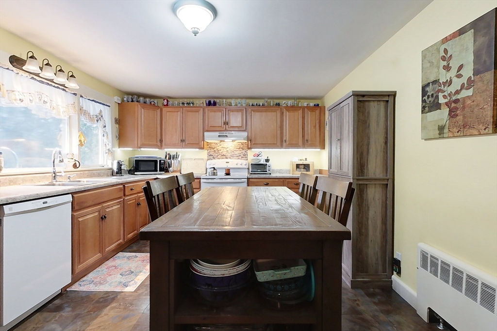 19 Mill Road Littleton, MA 01460 - Photo 7 of 31 a kitchen with kitchen island granite countertop a sink stove and refrigerator