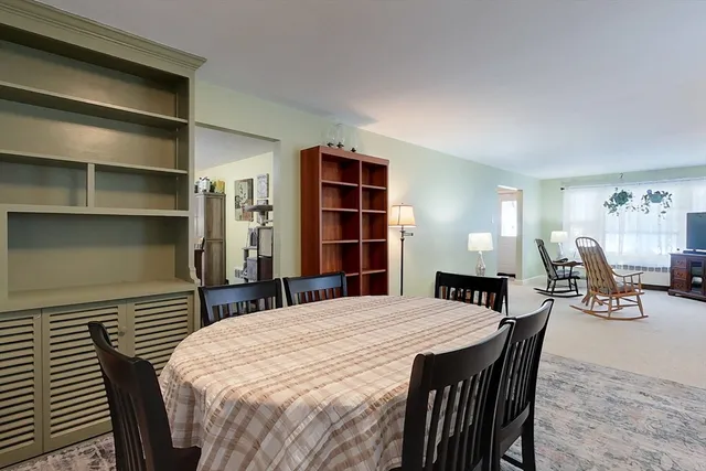 a bedroom with a bed and closet with chair