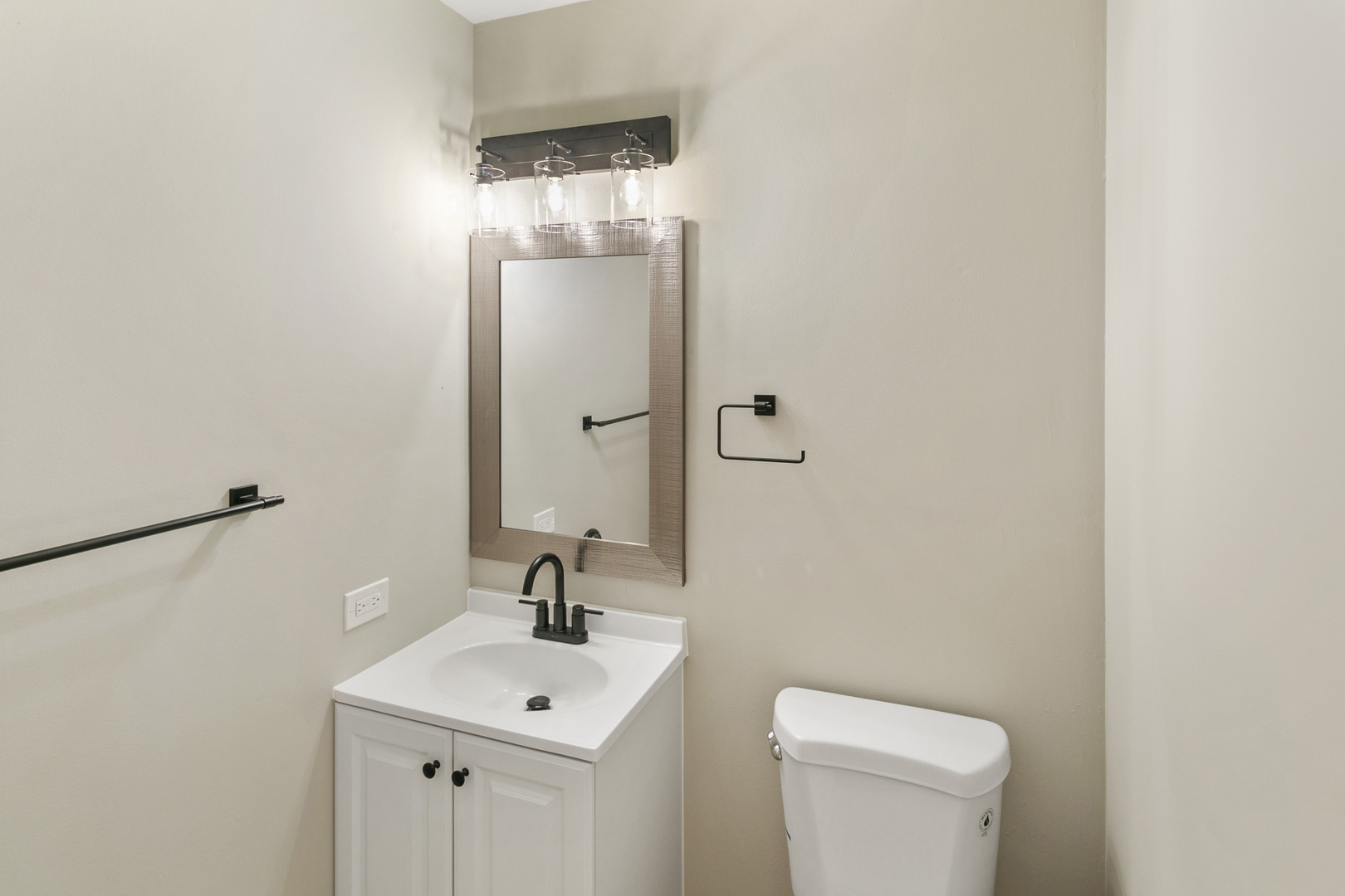 3618 Ronald Road Crete, IL 60417 - Photo 9 of 28 a bathroom with a toilet a sink and mirror