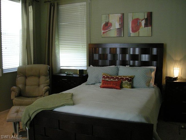 9245 Lanthorn Way Estero, FL 33928 - Photo 3 of 6 a bed sitting in a bedroom next to a window