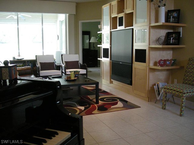 9245 Lanthorn Way Estero, FL 33928 - Photo 4 of 6 a kitchen with a sink appliances and cabinets