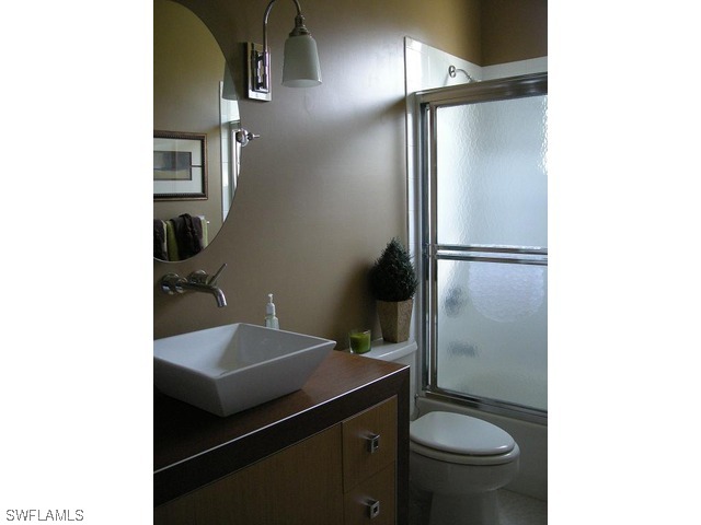 9245 Lanthorn Way Estero, FL 33928 - Photo 5 of 6 a bathroom with a sink toilet and shower