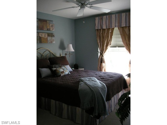 9245 Lanthorn Way Estero, FL 33928 - Photo 6 of 6 a bedroom with a bed and a window