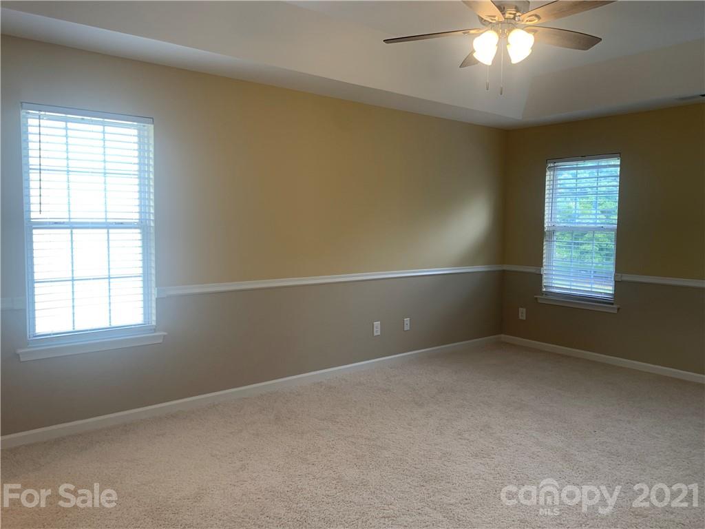 136 Royalton Road Mooresville, NC 28115 - Photo 13 of 28 an empty room with windows and chandelier fan