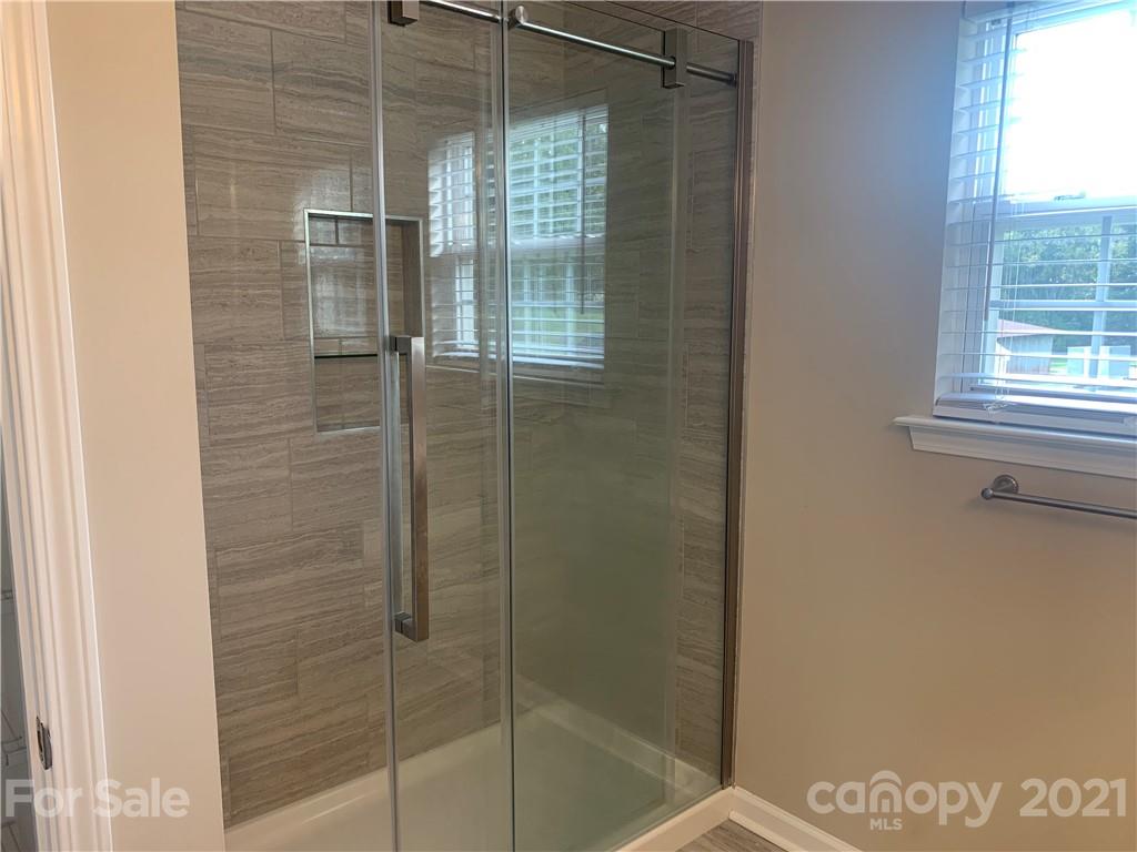 136 Royalton Road Mooresville, NC 28115 - Photo 16 of 28 a bathroom with a glass shower door