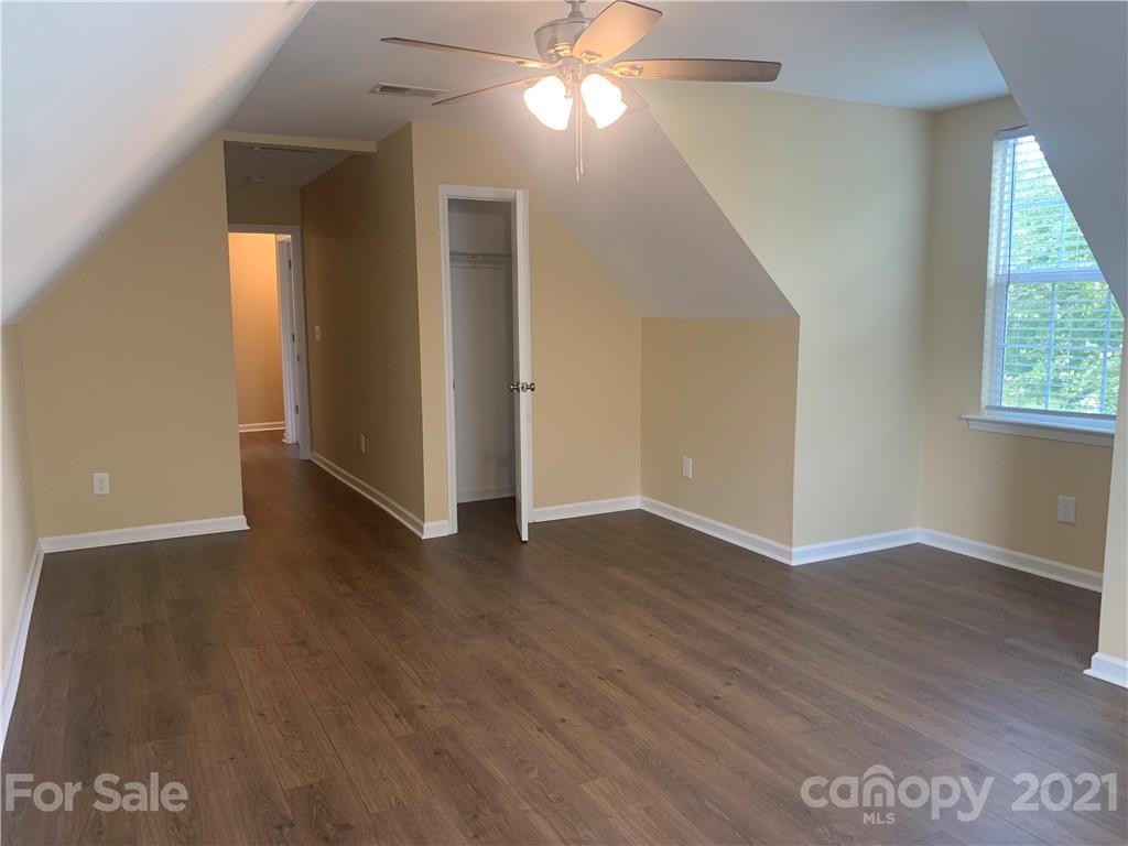 136 Royalton Road Mooresville, NC 28115 - Photo 19 of 28 an empty room with wooden floor and windows