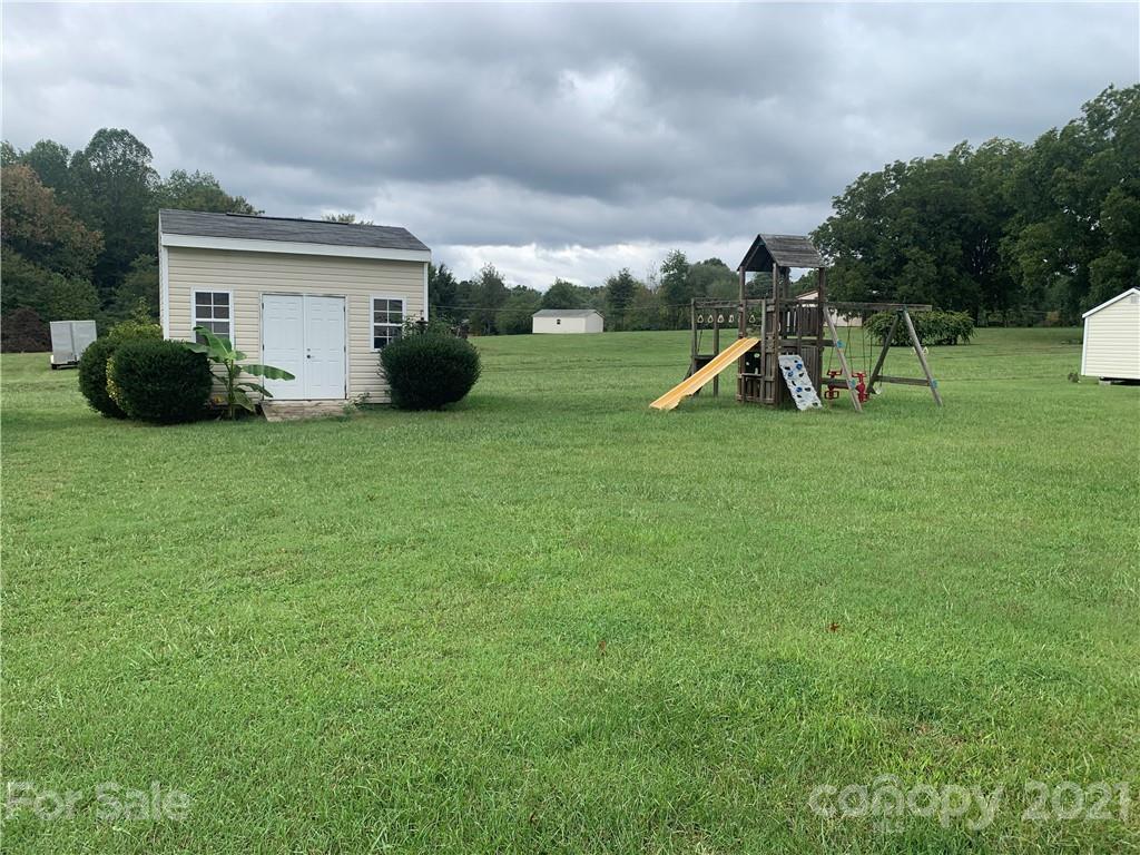 136 Royalton Road Mooresville, NC 28115 - Photo 3 of 28 a view of a house with backyard and a slide