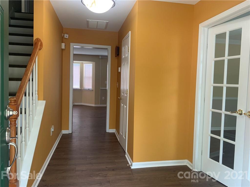 136 Royalton Road Mooresville, NC 28115 - Photo 6 of 28 a view of a hallway with wooden floor and windows