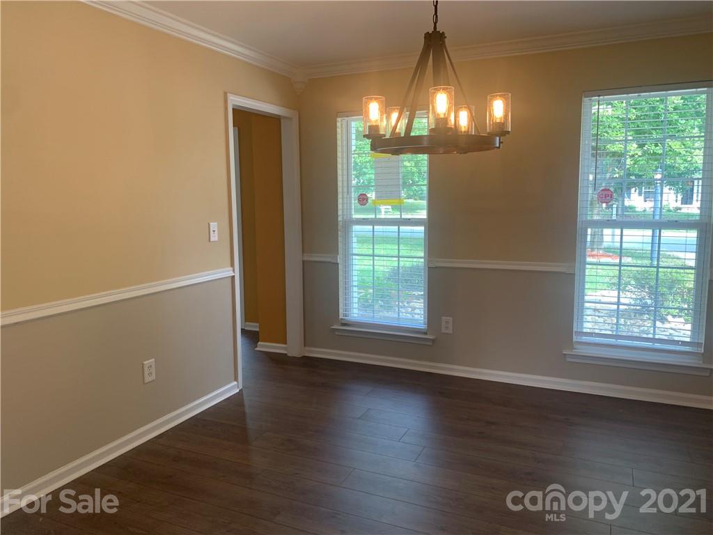 136 Royalton Road Mooresville, NC 28115 - Photo 8 of 28 an empty room with wooden floor and windows