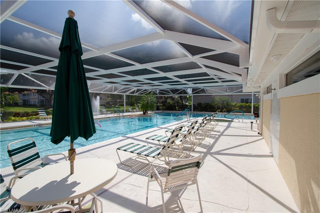 7648 Oleander Gate Drive, Unit 202 Naples, FL 34109 - Photo 18 of 23 a view of swimming pool with seating area