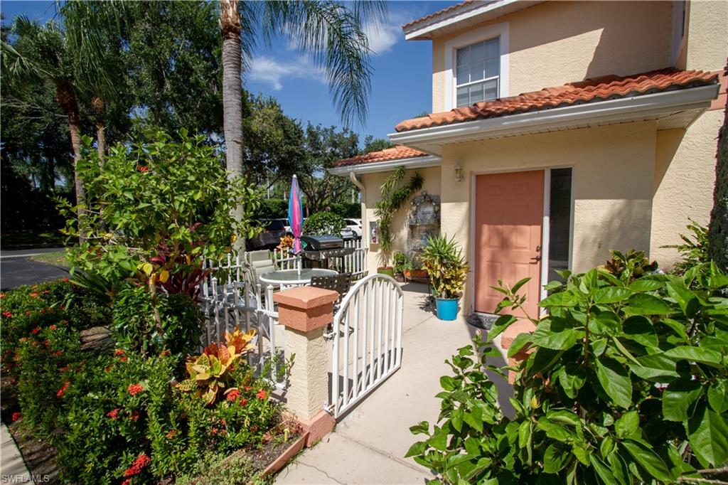 7648 Oleander Gate Drive, Unit 202 Naples, FL 34109 - Photo 3 of 23 a view of a house with fountain and potted plants