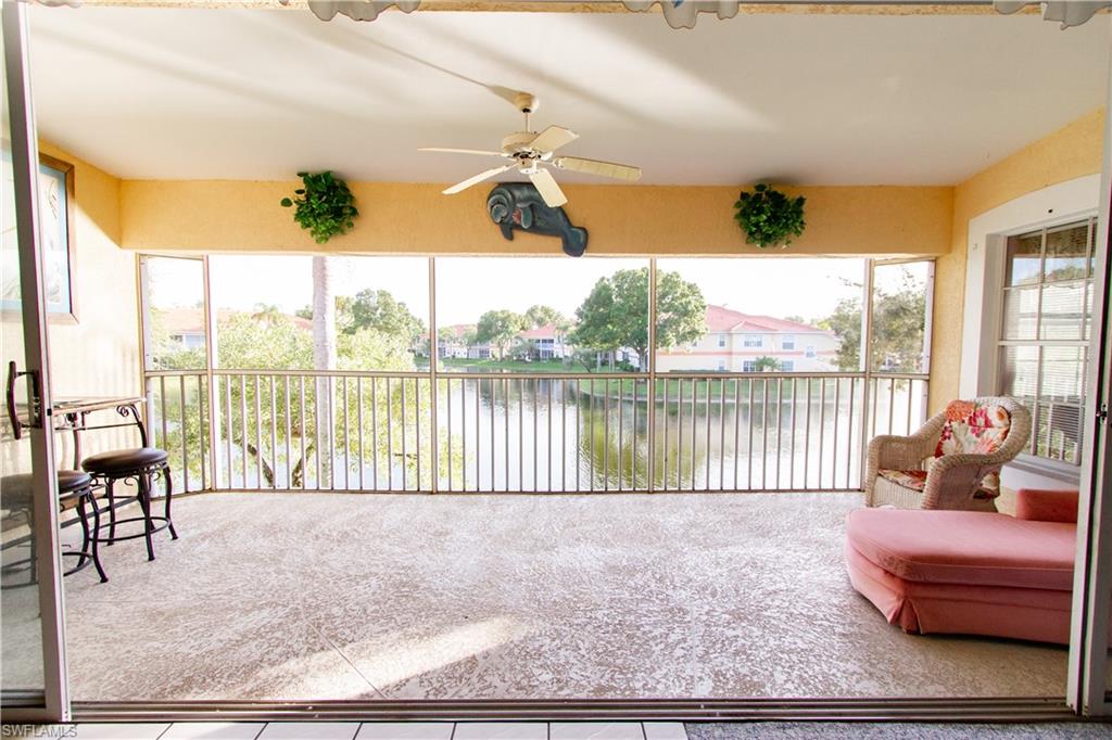 7648 Oleander Gate Drive, Unit 202 Naples, FL 34109 - Photo 5 of 23 a living room filled with furniture and a floor to ceiling window