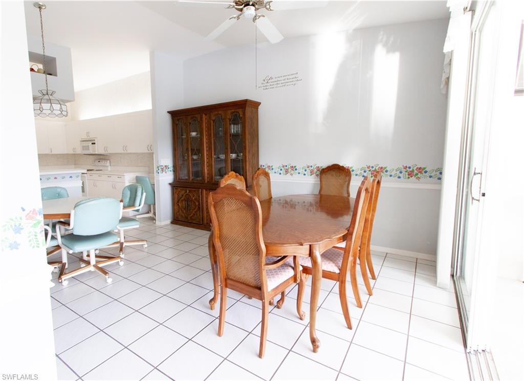 7648 Oleander Gate Drive, Unit 202 Naples, FL 34109 - Photo 10 of 23 a view of a dining room with furniture