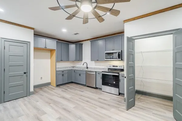 a kitchen with stainless steel appliances a refrigerator sink and cabinets