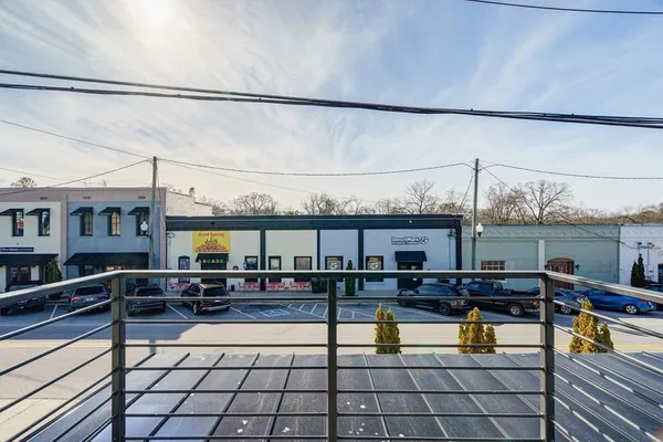 a living room with furniture a rug and kitchen view