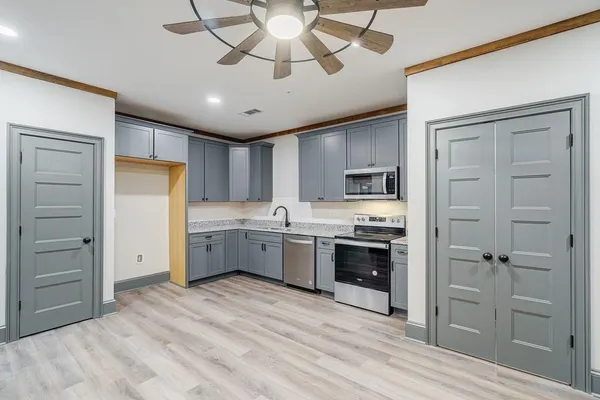 a kitchen with stainless steel appliances a refrigerator sink and cabinets