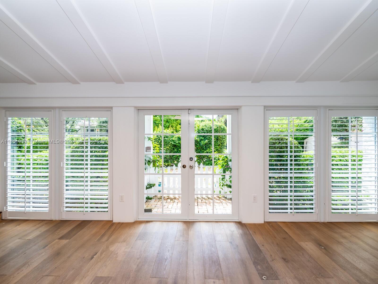 4700 Lake Road Miami, FL 33137 - Photo 12 of 92 a view of an empty room with wooden floor and a window