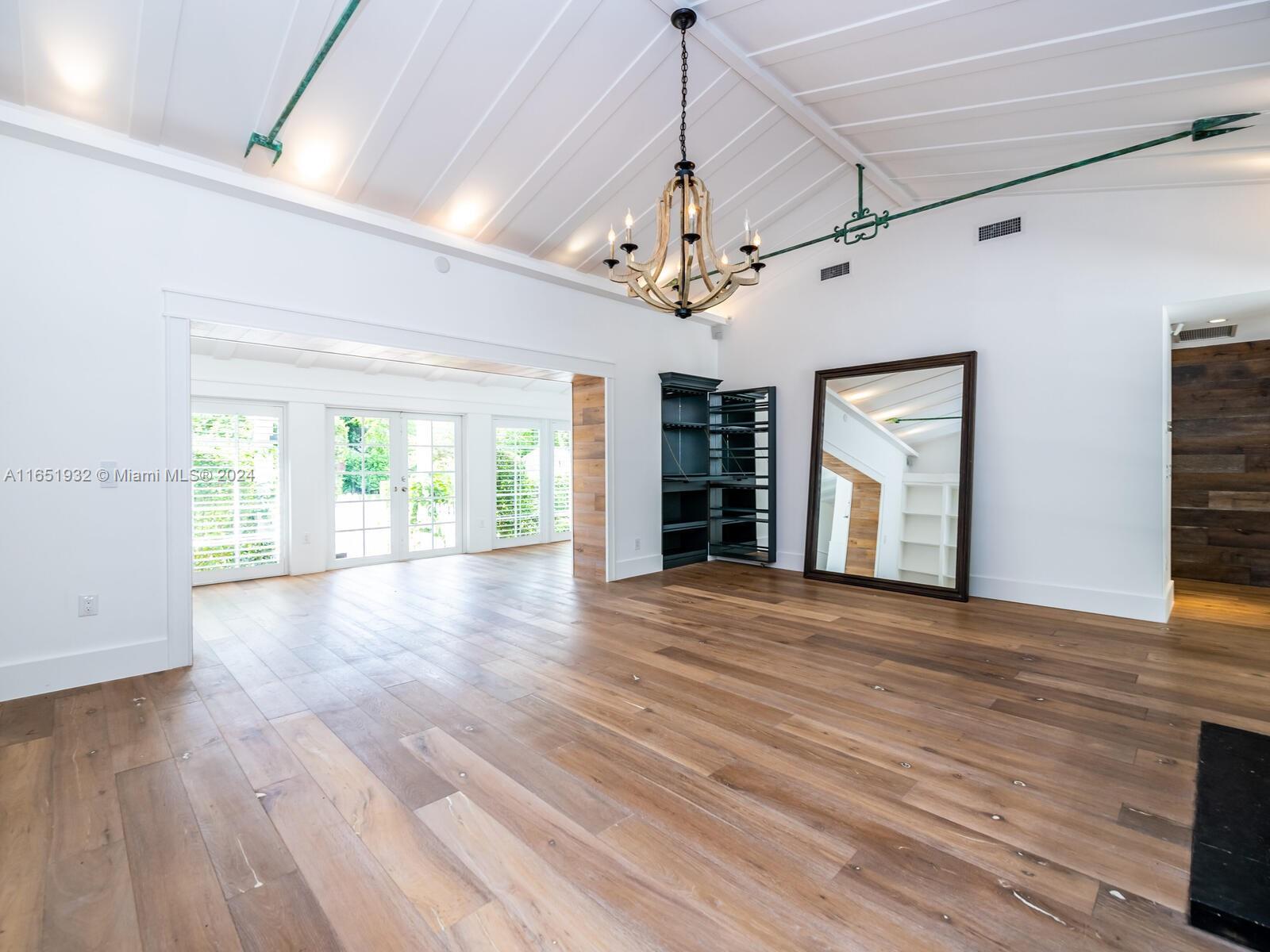 4700 Lake Road Miami, FL 33137 - Photo 16 of 92 a view of an empty room with a window and wooden floor