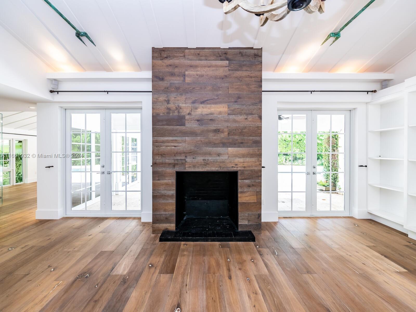4700 Lake Road Miami, FL 33137 - Photo 17 of 92 wooden floor fireplace and windows in an empty room