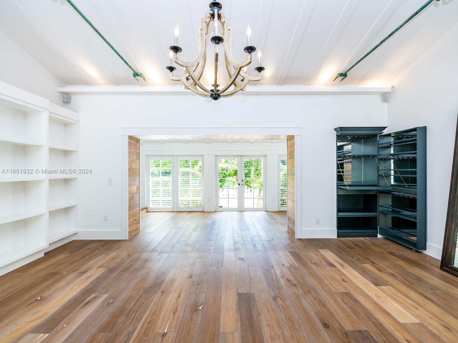 4700 Lake Road Miami, FL 33137 - Photo 18 of 92 a view of empty room with wooden floor and fan