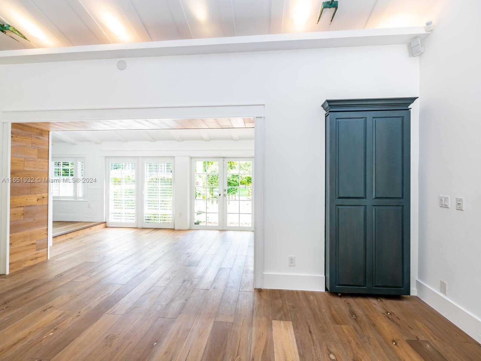 4700 Lake Road Miami, FL 33137 - Photo 21 of 92 an empty room with wooden floor and windows