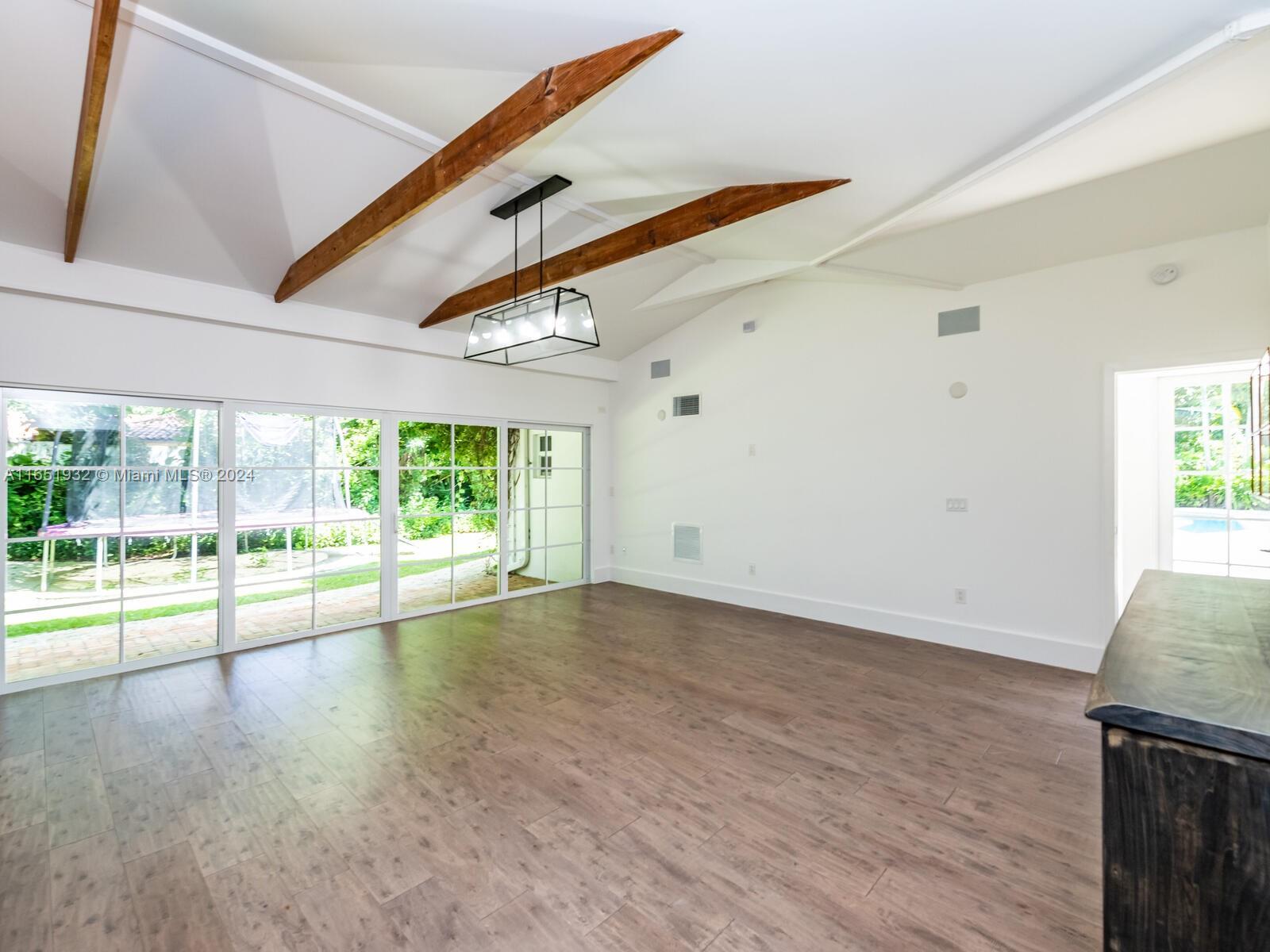 4700 Lake Road Miami, FL 33137 - Photo 31 of 92 a view of an empty room with wooden floor and a ceiling fan