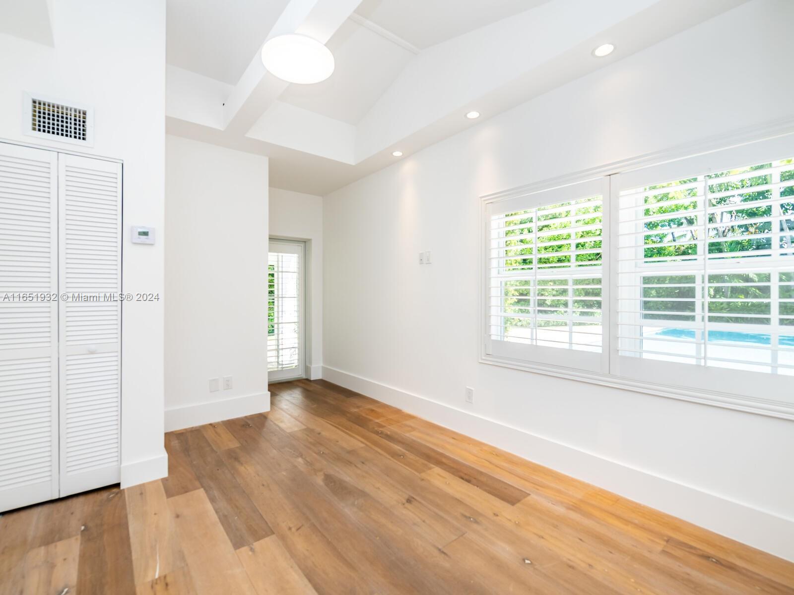4700 Lake Road Miami, FL 33137 - Photo 32 of 92 a view of an empty room with wooden floor and a window