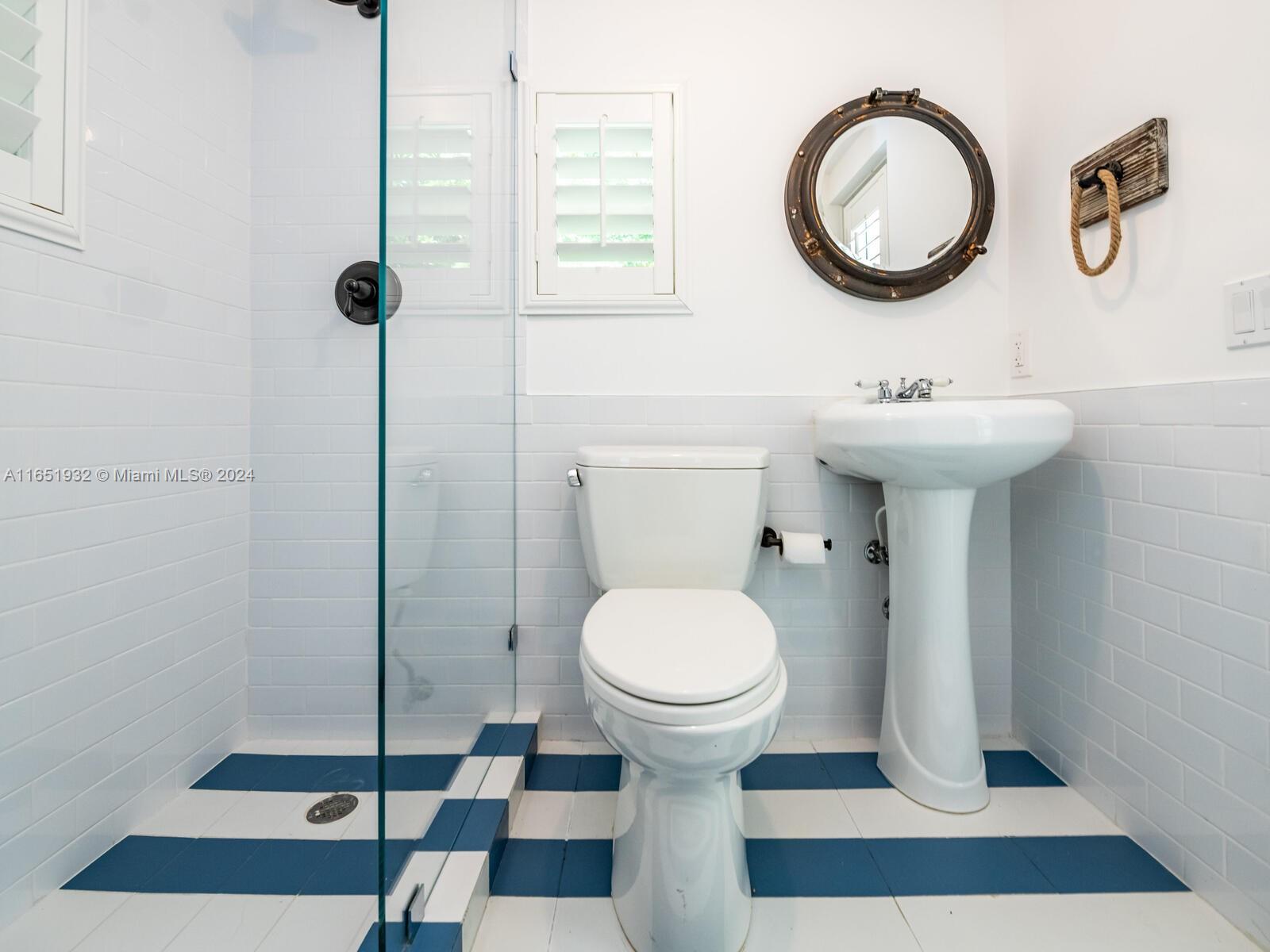 4700 Lake Road Miami, FL 33137 - Photo 34 of 92 a bathroom with a sink toilet and a mirror