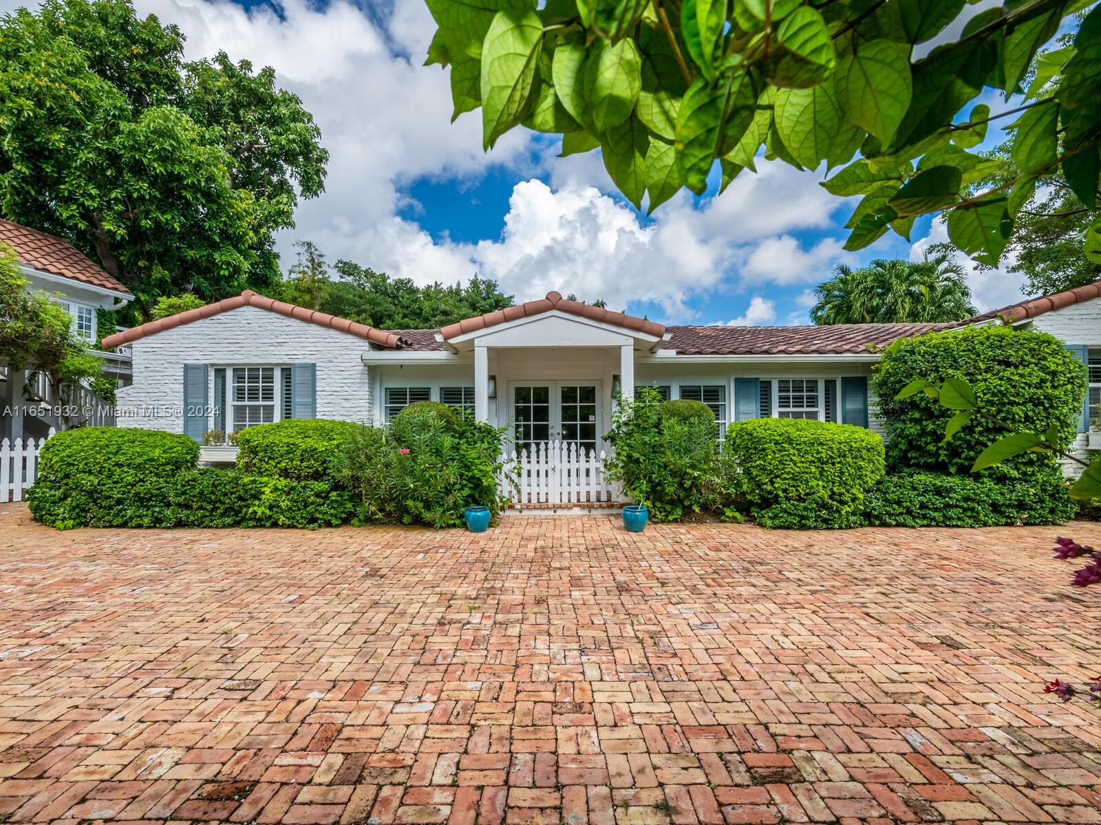 4700 Lake Road Miami, FL 33137 - Photo 4 of 92 a front view of a house with a garden