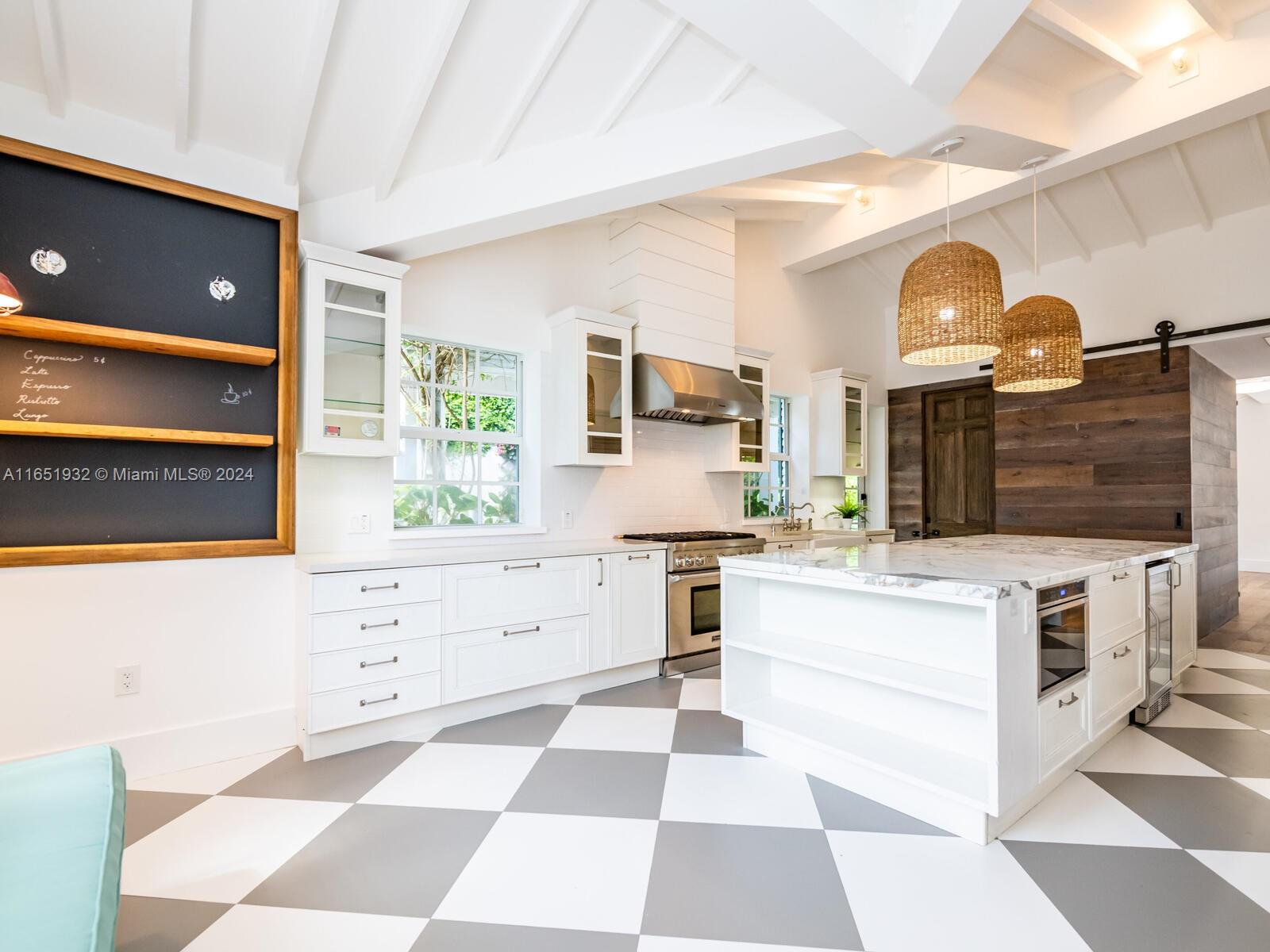 4700 Lake Road Miami, FL 33137 - Photo 49 of 92 a kitchen with a stove a sink and a refrigerator