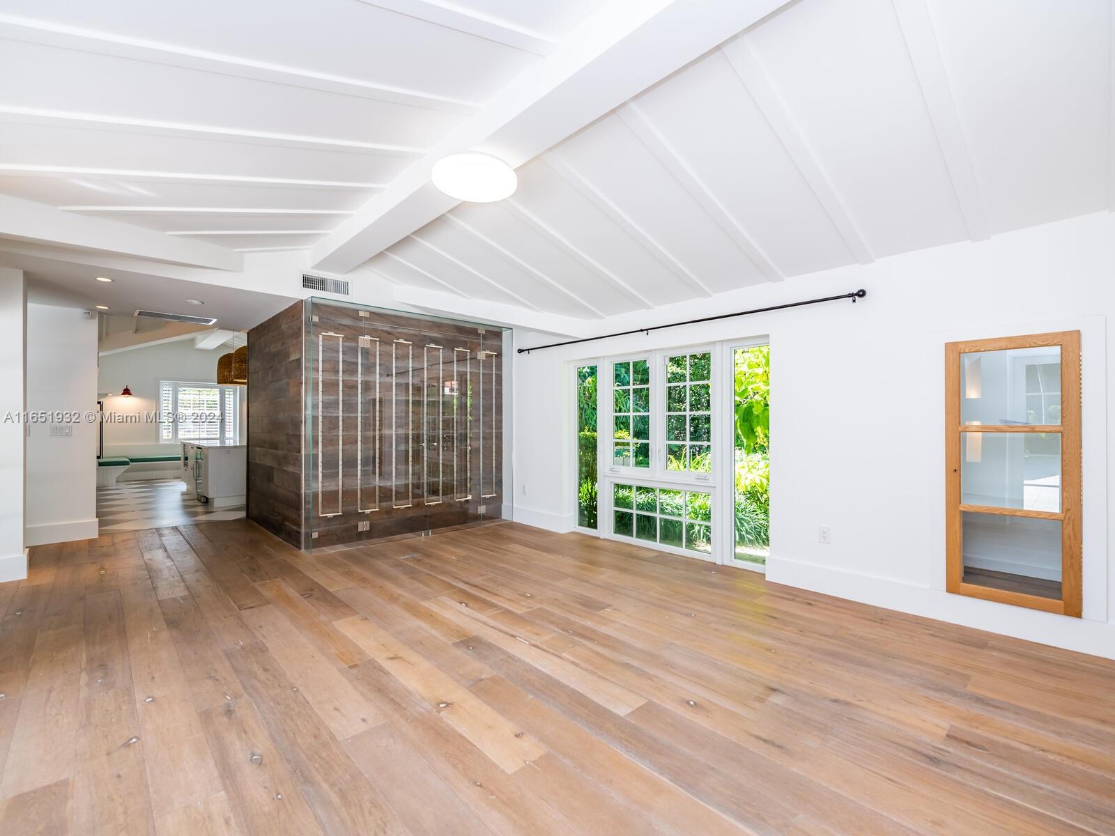 4700 Lake Road Miami, FL 33137 - Photo 56 of 92 a view of an empty room with wooden floor and a window