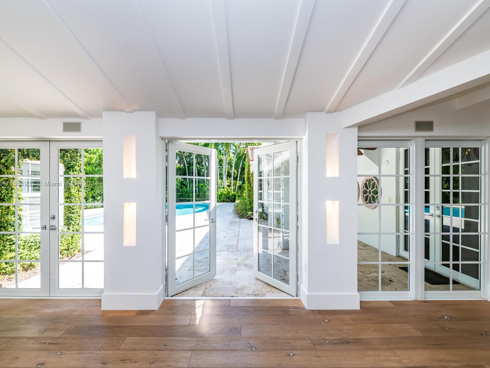 4700 Lake Road Miami, FL 33137 - Photo 57 of 92 a view of a big room with wooden floor and windows