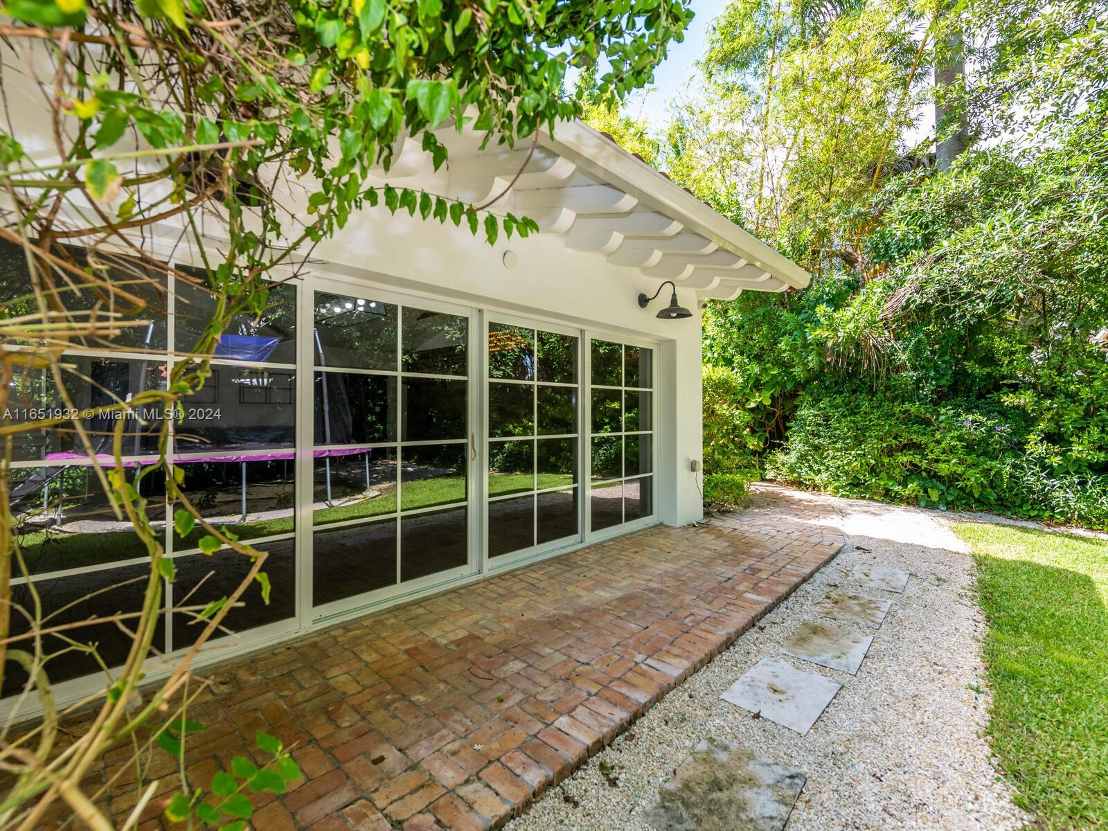 4700 Lake Road Miami, FL 33137 - Photo 65 of 92 a view of a house with a large window and potted plants