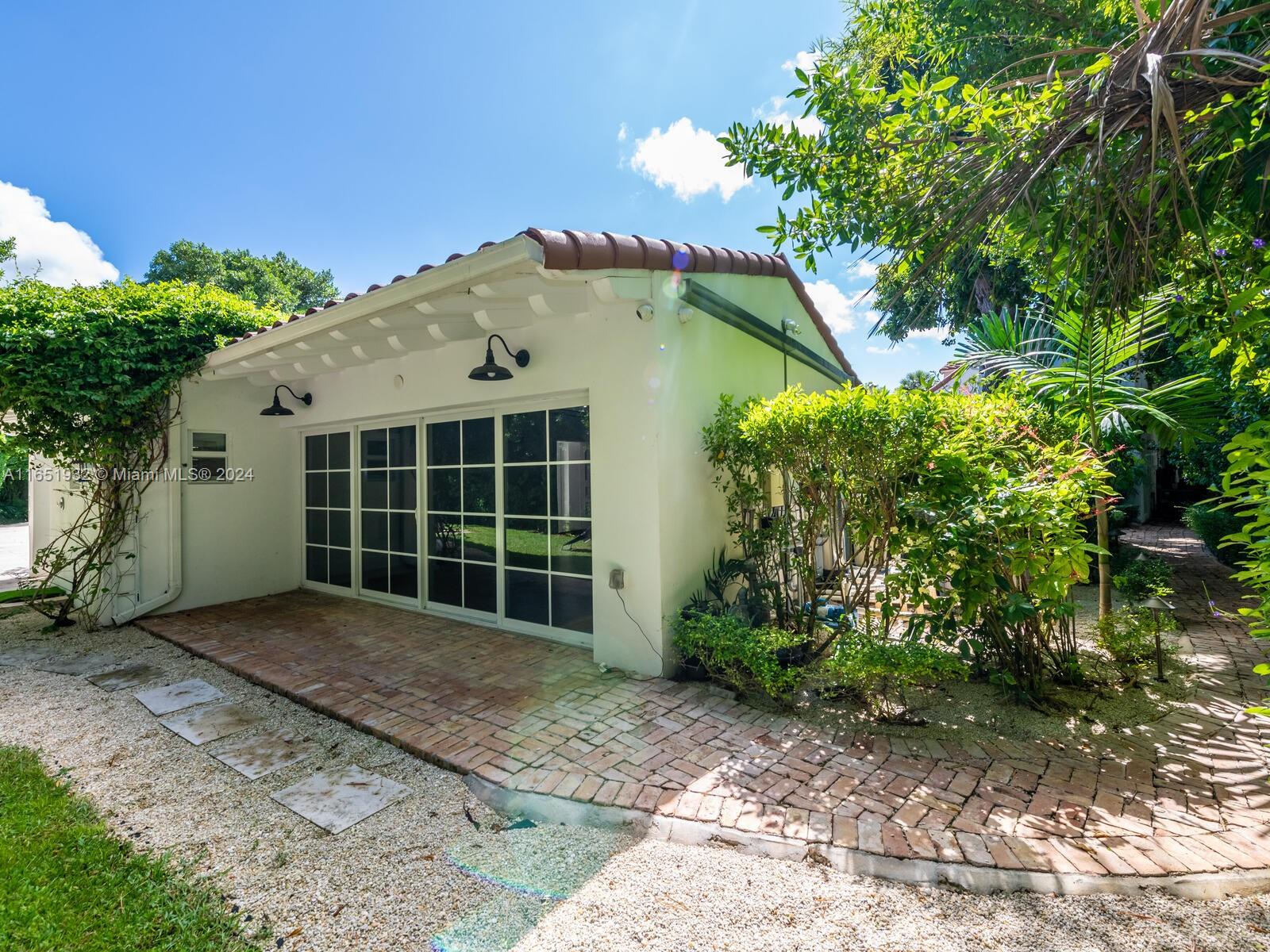 4700 Lake Road Miami, FL 33137 - Photo 66 of 92 a front view of a house with a garden