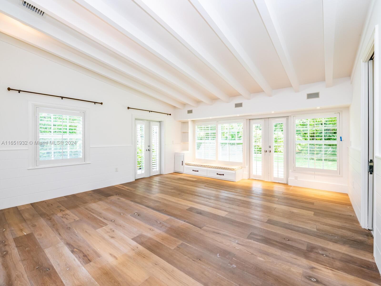 4700 Lake Road Miami, FL 33137 - Photo 82 of 92 a view of an empty room with wooden floor and a window