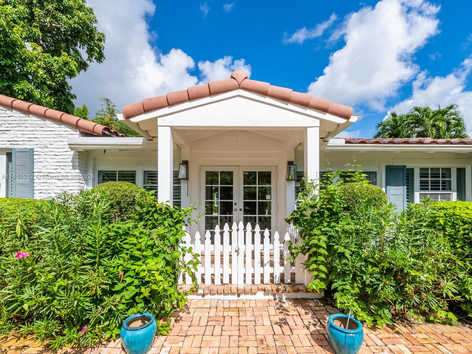 4700 Lake Road Miami, FL 33137 - Photo 10 of 92 a front view of a house with a garden