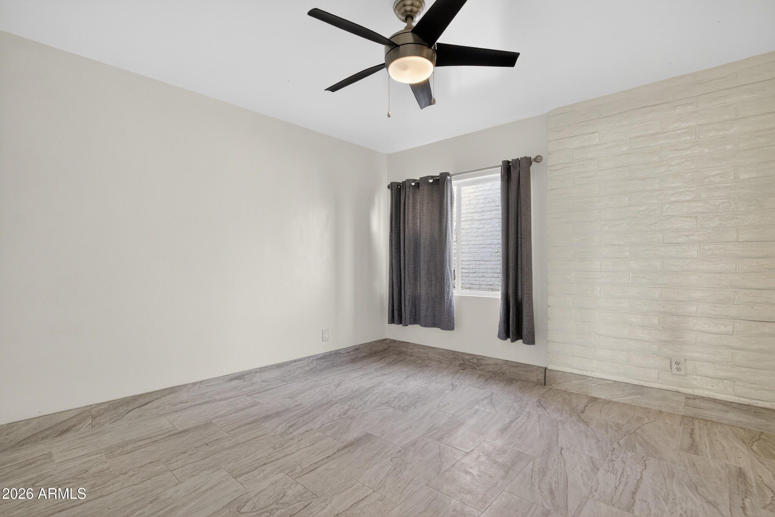 2925 North 38th Street, Unit 2 Phoenix, AZ 85018 - Photo 12 of 19 an empty room with wooden floor and windows
