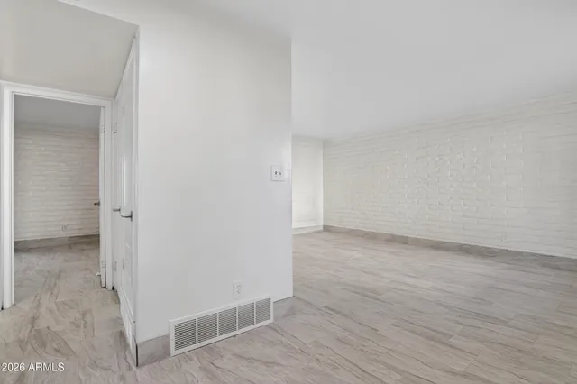 a view of a kitchen with a sink and a refrigerator