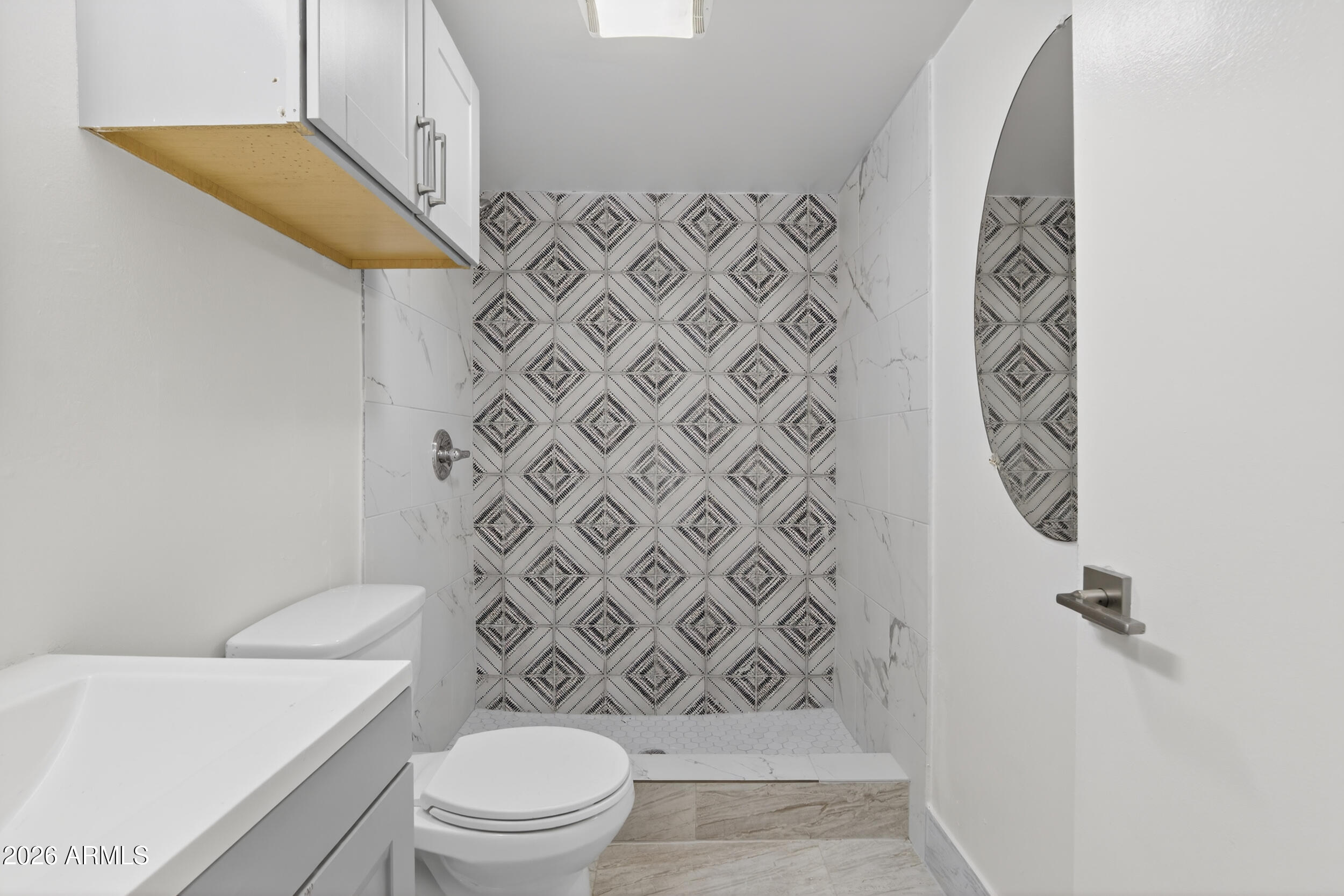 2925 North 38th Street, Unit 2 Phoenix, AZ 85018 - Photo 16 of 19 a bathroom with a toilet and a shower curtain