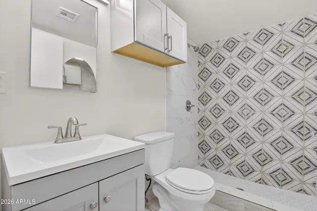 a bathroom with a toilet and a shower curtain