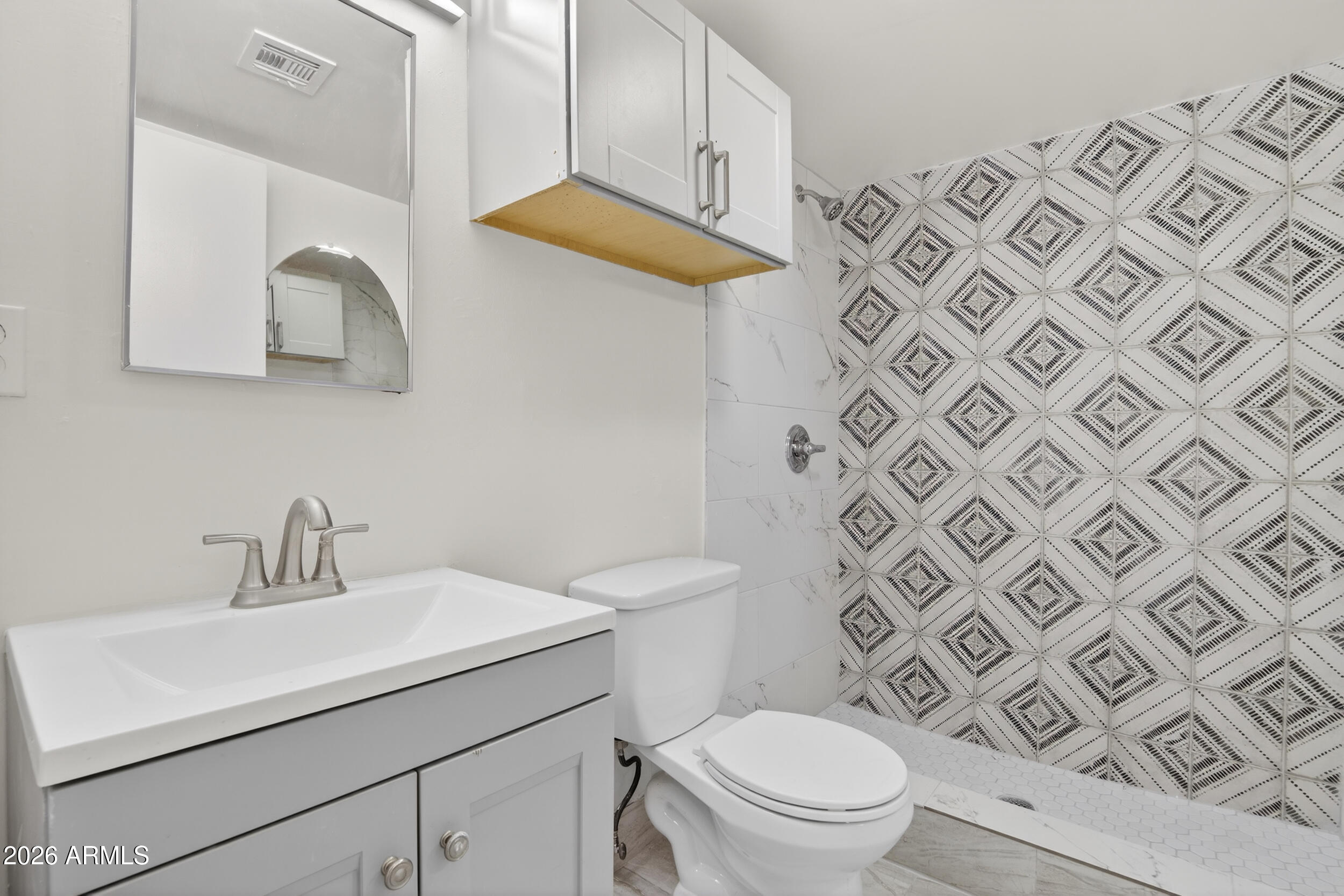 2925 North 38th Street, Unit 2 Phoenix, AZ 85018 - Photo 20 of 21 a bathroom with a sink mirror and toilet