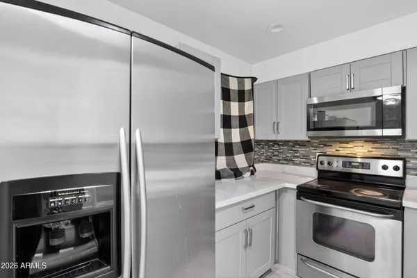 a kitchen with a refrigerator stove and microwave