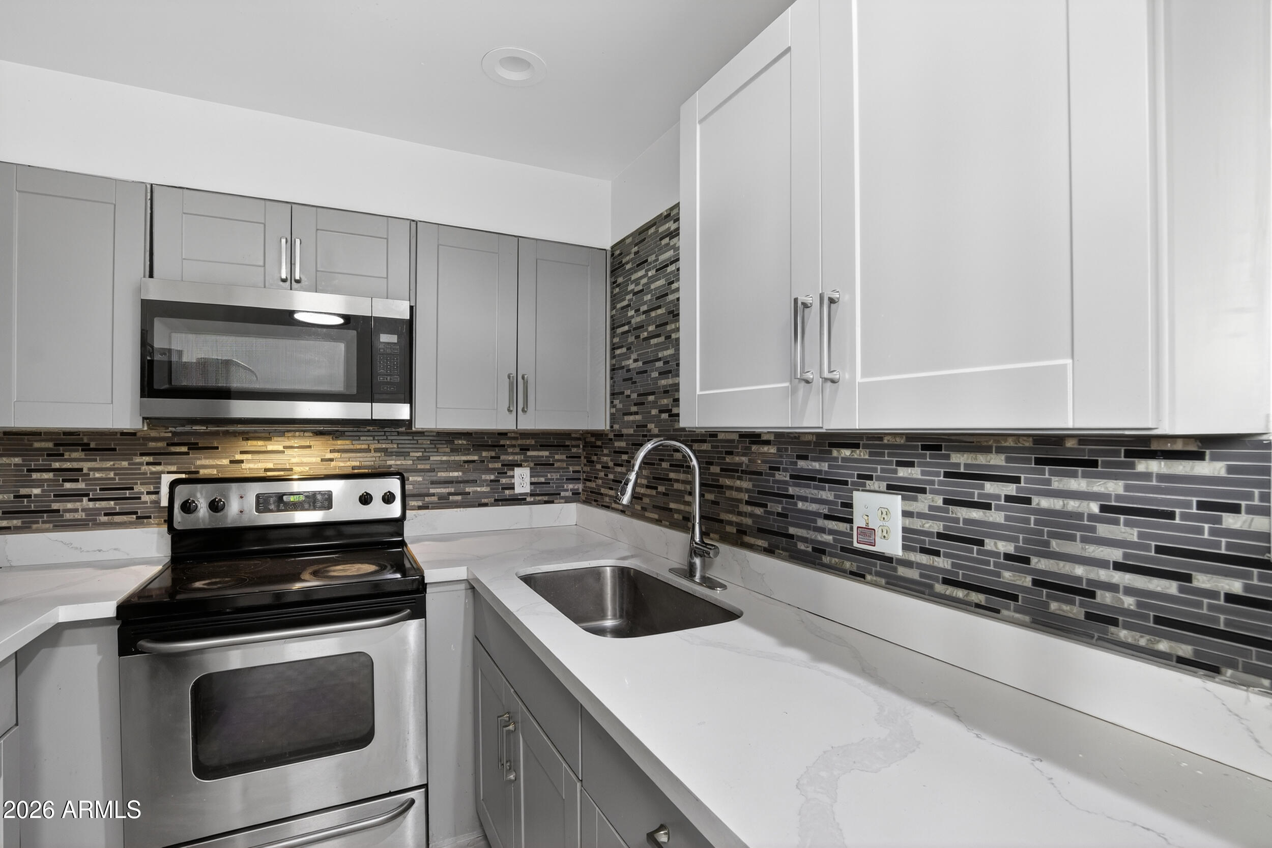 2925 North 38th Street, Unit 2 Phoenix, AZ 85018 - Photo 10 of 21 a kitchen with a stove and a microwave