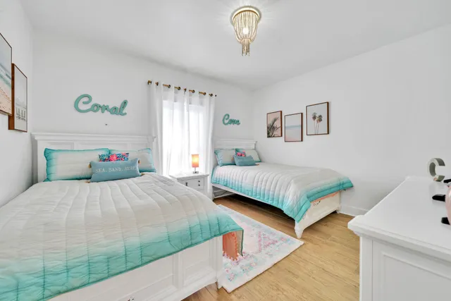 a view of a dining room with furniture and a chandelier