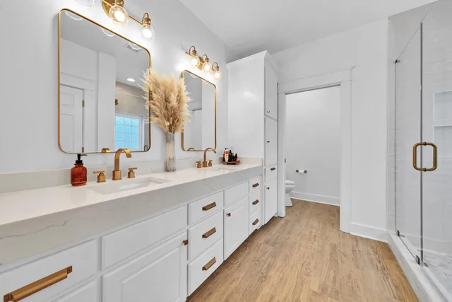 a bedroom with two beds and painting on the wall