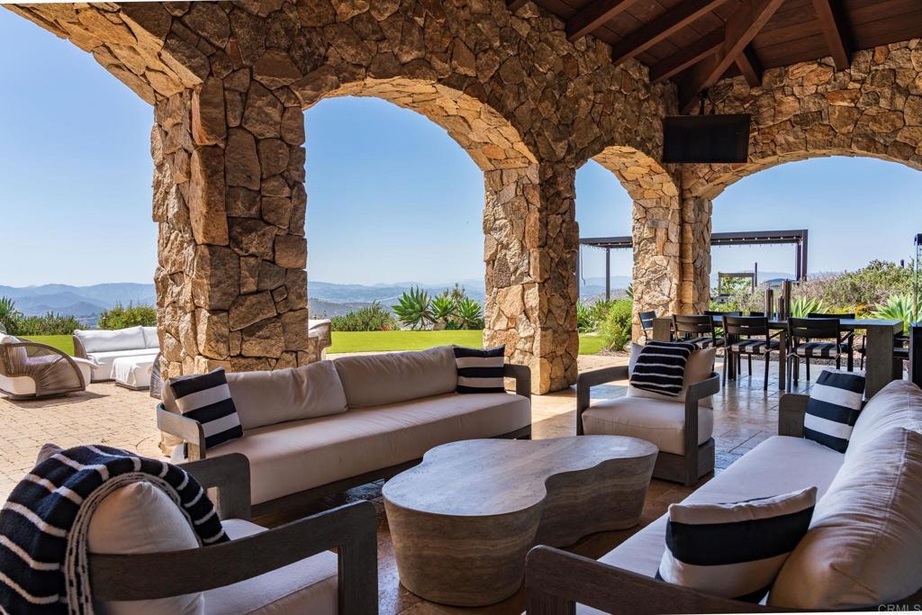 18000 Sunset Point Road Poway, CA 92064 - Photo 11 of 36 a living room with furniture and a floor to ceiling window