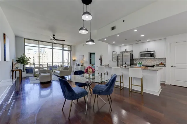 a view of kitchen with cabinets table and chairs