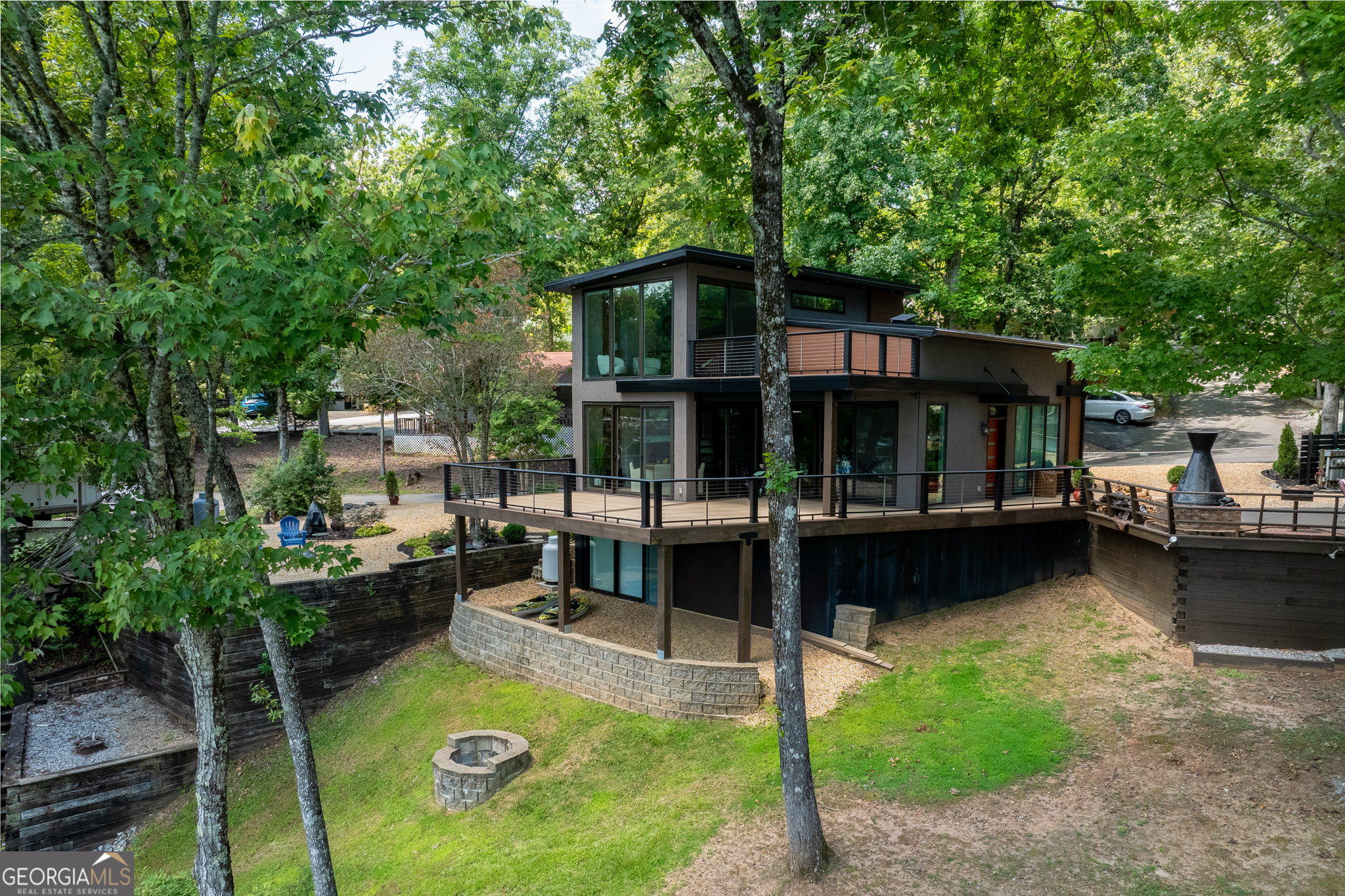 a view of swimming pool with lawn chairs and plants