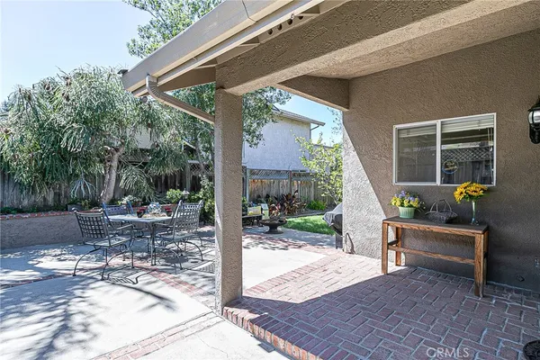 a view of a patio with a table and chairs